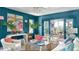 Stylish blue living room featuring chic furnishings, vibrant artwork, and doors leading to an outdoor patio at 791 Hughes Rd, Johns Island, SC 29455