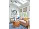 Bright living room featuring a modern sofa, unique coffee table, stylish lighting, and contemporary artwork at 791 Hughes Rd, Johns Island, SC 29455