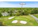 Aerial view of property at 8A Duffers Ct. overlooking a golf course with verdant landscape and nearby residences at 8 Duffers Ct. # A, Charleston, SC 29414