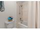 Bathroom featuring a tub with shower, neutral tile, and a white toilet at 8 Duffers Ct. # A, Charleston, SC 29414