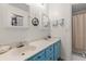 Bathroom features dual sinks with bright blue cabinetry, a framed mirror, and neutral walls at 8 Duffers Ct. # A, Charleston, SC 29414