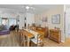 Dining room boasts hardwood floors, natural light, and an adjacent living area with a fireplace at 8 Duffers Ct. # A, Charleston, SC 29414
