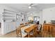 Sunlit dining room featuring hardwood floors, a wooden table set, and built-in storage at 8 Duffers Ct. # A, Charleston, SC 29414