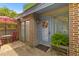 Cozy front patio with a brick floor, outdoor seating, and decorative plants near the entry at 8 Duffers Ct. # A, Charleston, SC 29414