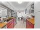 Galley kitchen featuring tile floors, a window, and red and white cabinets and drawers at 8 Duffers Ct. # A, Charleston, SC 29414