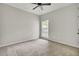 The bedroom includes a ceiling fan, neutral walls, carpeted floors, and a window at 8001 Hydrangea Ln, Hanahan, SC 29410