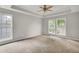 Bright bedroom with large windows and a tray ceiling at 8001 Hydrangea Ln, Hanahan, SC 29410