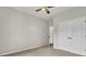 This bedroom includes a ceiling fan, neutral walls, carpeted floors, and a closet at 8001 Hydrangea Ln, Hanahan, SC 29410