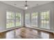 Bedroom with hardwood floors and large windows, offering natural light and outdoor views at 8001 Hydrangea Ln, Hanahan, SC 29410