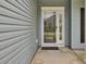 Inviting front entrance with glass features around the door and the house number above the door at 8001 Hydrangea Ln, Hanahan, SC 29410
