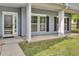 Inviting front entrance with white columns, large windows, and a storm door at the front door at 8001 Hydrangea Ln, Hanahan, SC 29410