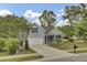 Charming single-Gathering home with an attached garage, established trees, and a well-maintained lawn at 8001 Hydrangea Ln, Hanahan, SC 29410