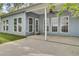Covered patio area with light blue siding, several windows, white trim and a ceiling fan at 8001 Hydrangea Ln, Hanahan, SC 29410