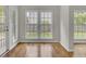 Sunroom filled with natural light, showcasing hardwood floors and backyard views at 8001 Hydrangea Ln, Hanahan, SC 29410
