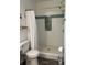 Shower featuring white and blue tiled walls and gold hardware at 928 Sycamore Ave, Charleston, SC 29407