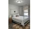 Spacious bedroom with a modern four-poster bed, neutral decor, and cozy area rug at 928 Sycamore Ave, Charleston, SC 29407