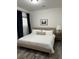 Cozy bedroom with an upholstered bed, side table, and natural light at 928 Sycamore Ave, Charleston, SC 29407