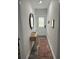 Hallway with a decorative mirror and a light wood console table on gray floors at 928 Sycamore Ave, Charleston, SC 29407