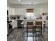 Bright kitchen features white cabinets, stainless steel appliances, and an island with seating at 928 Sycamore Ave, Charleston, SC 29407