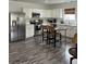 Kitchen featuring stainless steel refrigerator, white cabinets, grey flooring, and eat in area with bar stools at 928 Sycamore Ave, Charleston, SC 29407