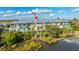 Aerial view of back of colorful townhomes overlooking a marshy landscape and serene waterway at 1011 Lighterman Way, Charleston, SC 29412