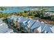 Scenic aerial view of colorful townhomes with metal roofs nestled amongst trees near the waterway at 1011 Lighterman Way, Charleston, SC 29412