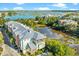 Aerial view of townhomes close to marsh with lush tropical landscaping and waterfront views at 1011 Lighterman Way, Charleston, SC 29412