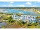 Aerial view of colorful townhomes near a bridge, showcasing a charming coastal community and marsh at 1011 Lighterman Way, Charleston, SC 29412