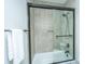 Modern bathroom with a glass-enclosed shower, neutral tile and a towel bar at 1011 Lighterman Way, Charleston, SC 29412