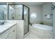 Bright bathroom features a large tub, a shower, and unique round windows at 1011 Lighterman Way, Charleston, SC 29412