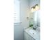 Well-lit bathroom featuring a granite countertop, vanity, and a window for natural light at 1011 Lighterman Way, Charleston, SC 29412