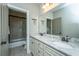 Bathroom with granite countertops, double vanity, and tiled shower and tub at 1011 Lighterman Way, Charleston, SC 29412