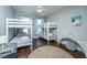 Bedroom featuring bunk beds, hardwood floors, and modern decor at 1011 Lighterman Way, Charleston, SC 29412