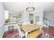 Dining area with a wooden table, chairs, bench seating, and view of the kitchen with bright lighting at 1011 Lighterman Way, Charleston, SC 29412