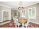Dining area with a wood table, seating for six, modern lighting, and wood floors at 1011 Lighterman Way, Charleston, SC 29412