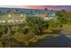 Scenic waterfront townhome featuring multiple units with decks, colorful exteriors, and lush landscaping with marsh view at 1011 Lighterman Way, Charleston, SC 29412
