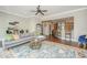 Spacious living room with a cozy rug, stylish furnishings, and hardwood floors with a partial view of the kitchen at 1011 Lighterman Way, Charleston, SC 29412