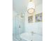 Bright bathroom with a soaking tub and a glass shower, with whimsical gold star wallpaper at 1075 Avenue Of Oaks, Charleston, SC 29407