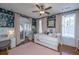 Bedroom with a whimsical wallpaper, pink accents, desk, and white daybed at 1075 Avenue Of Oaks, Charleston, SC 29407