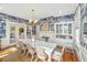 Dining room with blue wallpaper, a decorative fireplace, and a long table for gathering, and bright natural light at 1075 Avenue Of Oaks, Charleston, SC 29407