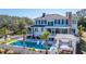 Stunning aerial view of home with a backyard pool, lounge area, and lush landscaping at 1075 Avenue Of Oaks, Charleston, SC 29407