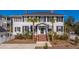 Charming two-story traditional home with white siding, black shutters, palm trees, and a welcoming front entrance at 1075 Avenue Of Oaks, Charleston, SC 29407
