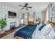Spacious bedroom with fireplace, neutral walls and a ceiling fan at 1075 Avenue Of Oaks, Charleston, SC 29407