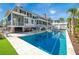 Backyard oasis with a sparkling pool, sun loungers, outdoor seating, and covered patio for ultimate relaxation at 1075 Avenue Of Oaks, Charleston, SC 29407