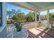 Covered porch with a view of the green lawn and lush surrounding trees at 1075 Avenue Of Oaks, Charleston, SC 29407