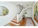 Open staircase with hardwood treads, white risers, and decorative lighting; showcasing seamless elegance at 1075 Avenue Of Oaks, Charleston, SC 29407