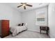 This charming bedroom features a ceiling fan, neutral carpet, and a window that allows natural light to flood the space at 113 Grimball St, Summerville, SC 29486