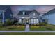 Charming two-story home with landscaped yard, inviting porch, and neutral siding in a quiet neighborhood at 113 Grimball St, Summerville, SC 29486