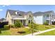 Charming two-story home with a well-maintained lawn, mature trees, and sidewalk at 113 Grimball St, Summerville, SC 29486