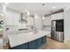 Modern kitchen boasts white cabinets, stainless appliances, a spacious island, and pendant lighting at 113 Grimball St, Summerville, SC 29486